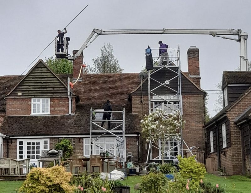 The Moss Cleaners using cherry picker and scaffolding to clean roof safely and professionally in Swindon, Wiltshire